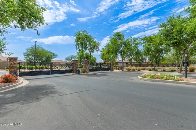 3400 S Whetstone Pl, Chandler, AZ 85286 - view of asphalt street with a gate, curbs, and a gated entry