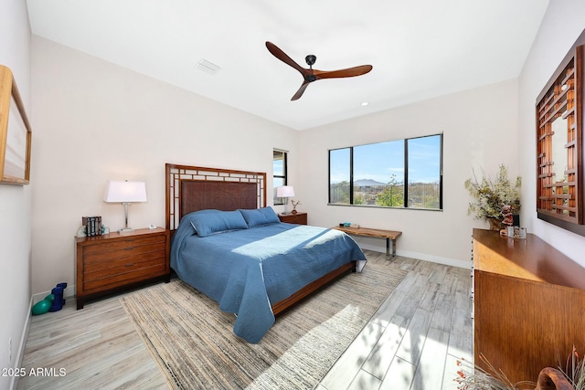 bedroom with ceiling fan and light wood-type flooring