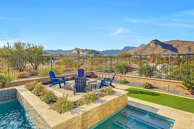 view of swimming pool with a mountain view and a patio area