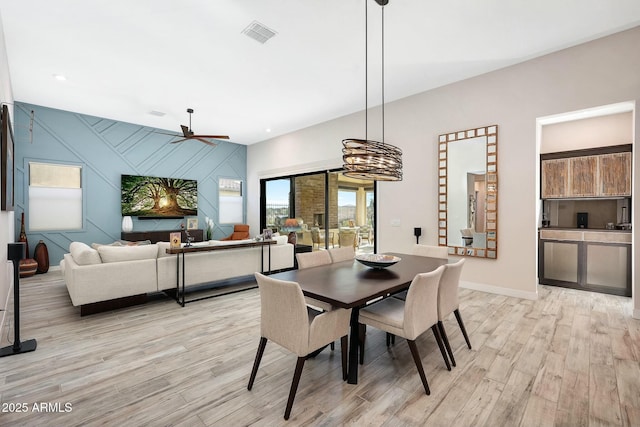 dining room with ceiling fan and light hardwood / wood-style floors