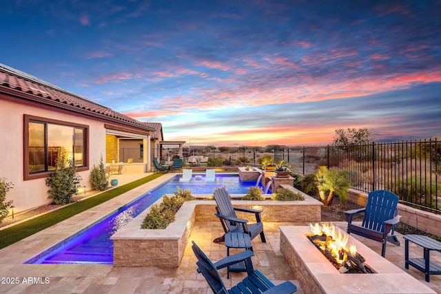 exterior space featuring pool water feature, a patio area, and a fire pit