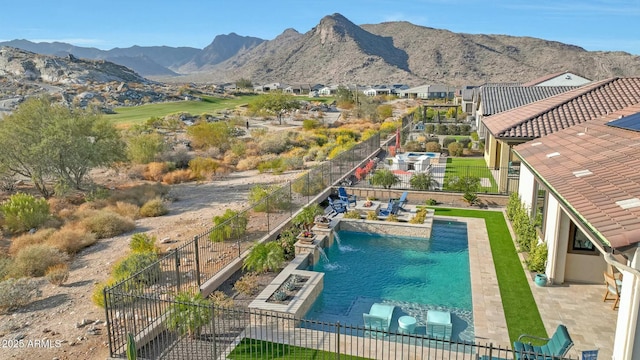 view of pool with a mountain view and a patio area