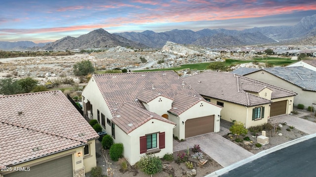 aerial view at dusk featuring a mountain view