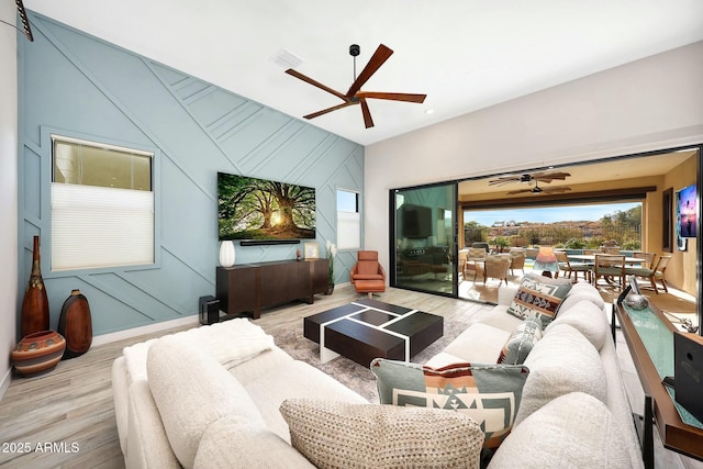 living room with light hardwood / wood-style floors and ceiling fan