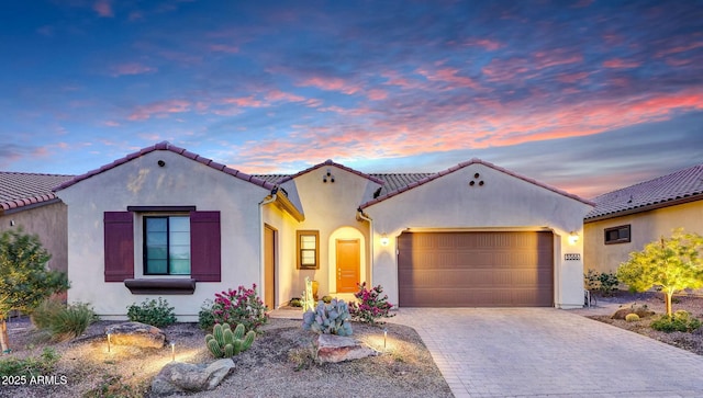 mediterranean / spanish house featuring a garage