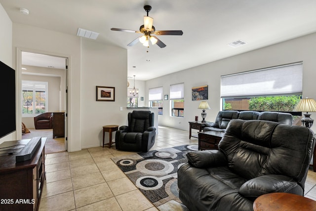 living area featuring a healthy amount of sunlight, visible vents, and light tile patterned floors