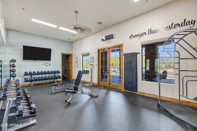 exercise room with baseboards and visible vents