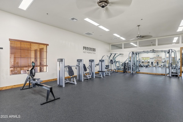 gym with a ceiling fan, baseboards, and visible vents