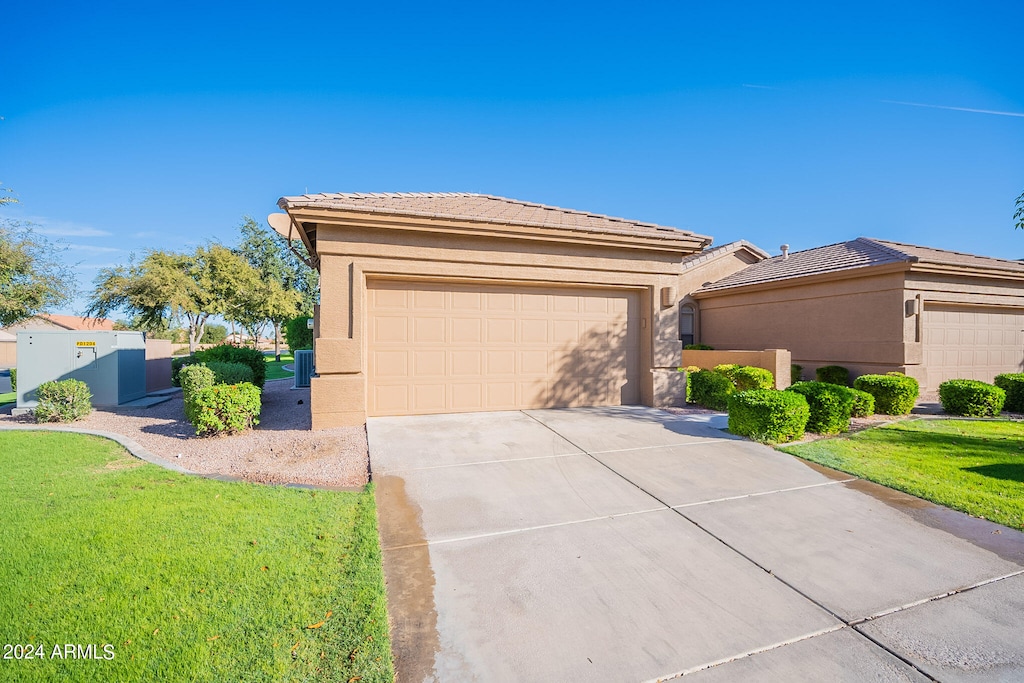 view of front of property with a front yard and a garage