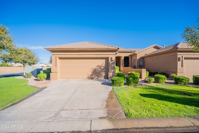 view of front of house featuring a front lawn and a garage