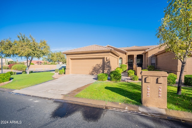 view of front of home featuring a front lawn and a garage