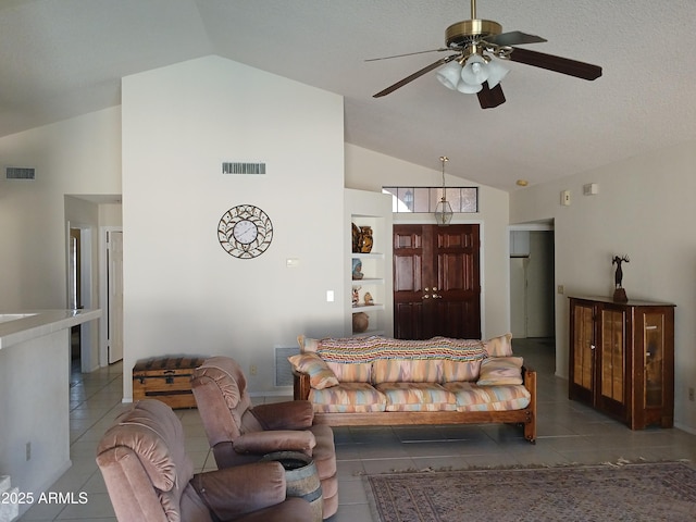 living room with ceiling fan, high vaulted ceiling, and dark tile patterned floors