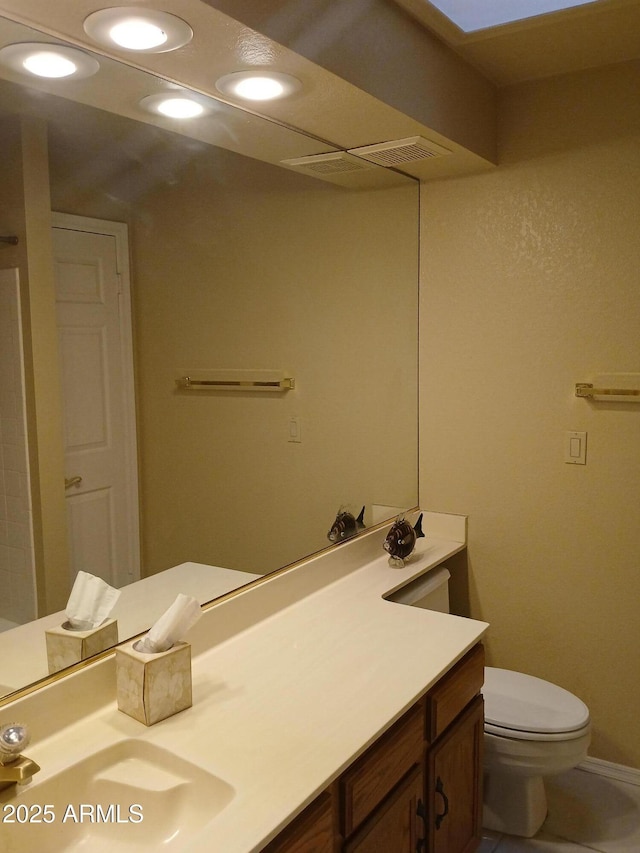 bathroom with vanity and toilet