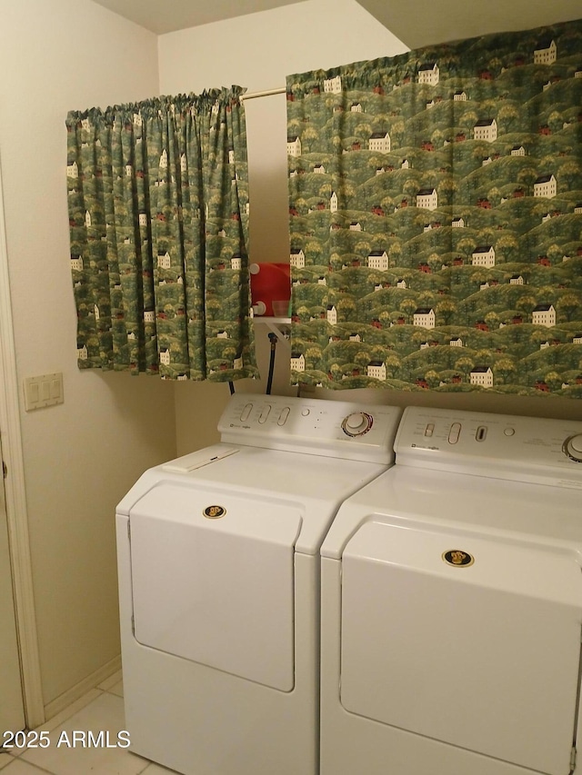 clothes washing area with tile patterned flooring and washer and dryer