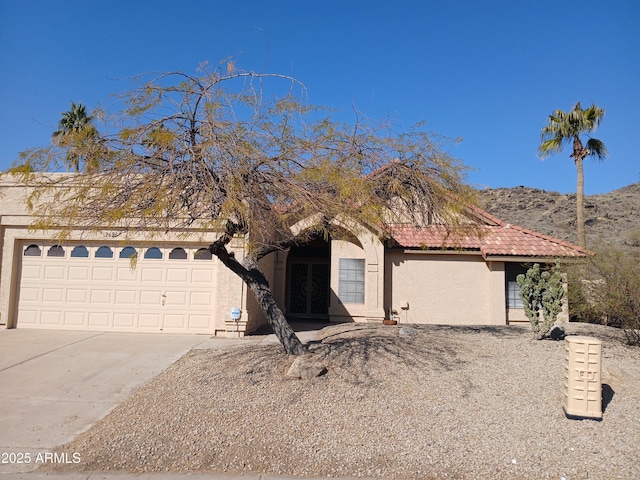 view of front of home featuring a mountain view and a garage