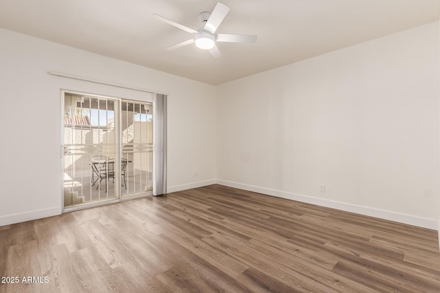 spare room featuring wood-type flooring and ceiling fan