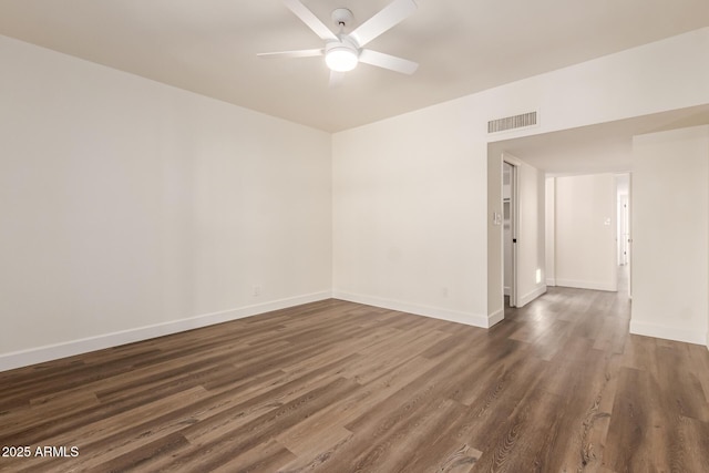 unfurnished room with dark wood-type flooring and ceiling fan