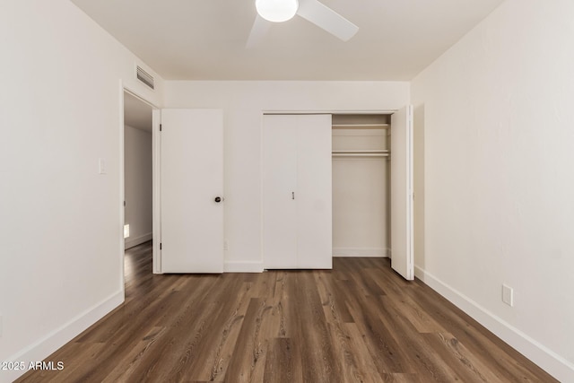 unfurnished bedroom featuring a closet, dark hardwood / wood-style floors, and ceiling fan