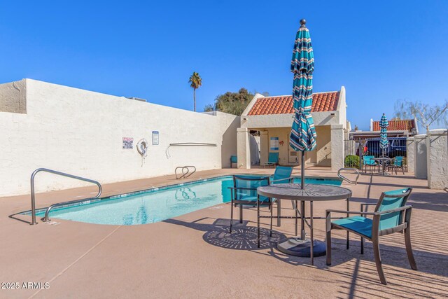 view of swimming pool with a patio