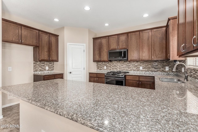 4151 Big Bend St, Sierra Vista, AZ 85650 - kitchen with stainless steel appliances, a sink, stone countertops, backsplash, and recessed lighting