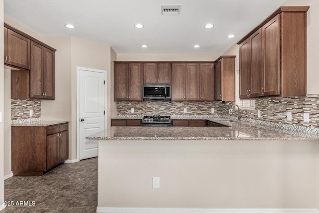 4151 Big Bend St, Sierra Vista, AZ 85650 - kitchen featuring stainless steel appliances, light stone countertops, recessed lighting, a peninsula, and backsplash