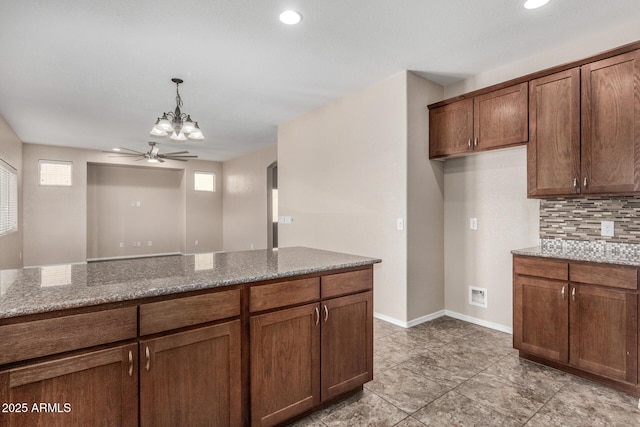 4151 Big Bend St, Sierra Vista, AZ 85650 - kitchen featuring a ceiling fan, stone countertops, hanging light fixtures, tasteful backsplash, and recessed lighting