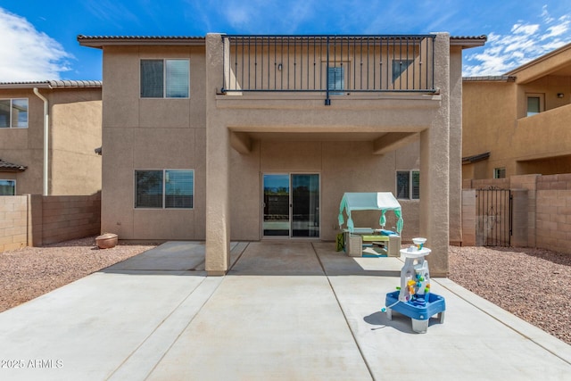 4151 Big Bend St, Sierra Vista, AZ 85650 - rear view of house featuring a balcony, stucco siding, a fenced backyard, and a patio