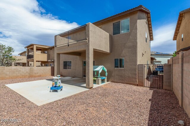 4151 Big Bend St, Sierra Vista, AZ 85650 - rear view of house featuring a balcony, stucco siding, a fenced backyard, a patio area, and a gate