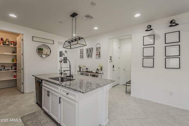 6566 E Via Arroyo Largo, Tucson, AZ 85756 - kitchen with light stone counters, light tile patterned flooring, white cabinets, decorative light fixtures, and recessed lighting