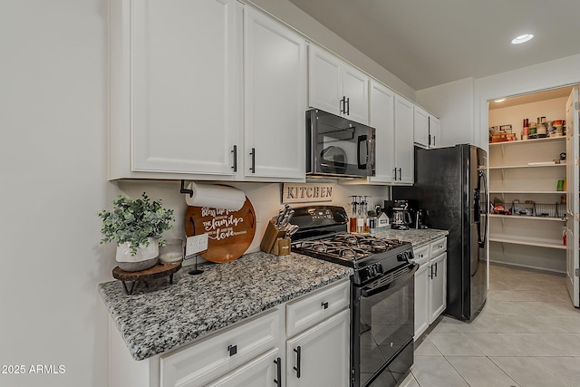 6566 E Via Arroyo Largo, Tucson, AZ 85756 - kitchen with black appliances, white cabinetry, light stone countertops, light tile patterned flooring, and recessed lighting
