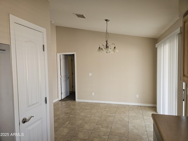 unfurnished dining area with an inviting chandelier, vaulted ceiling, and light tile patterned flooring