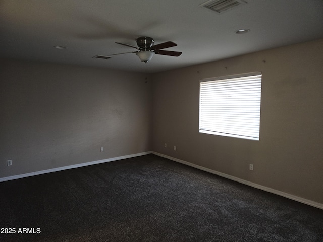 carpeted empty room featuring ceiling fan