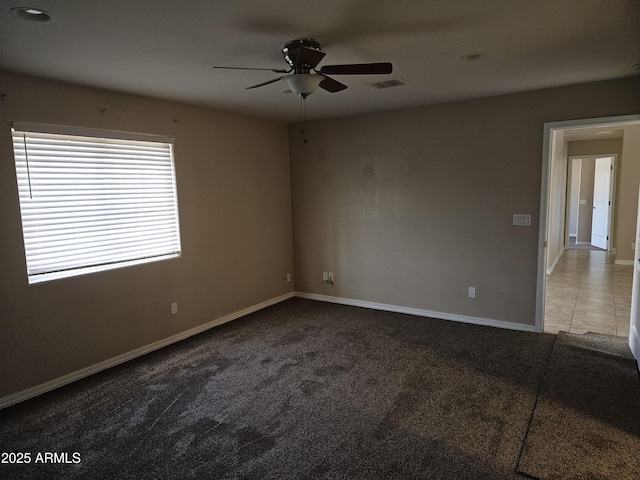 carpeted spare room with ceiling fan