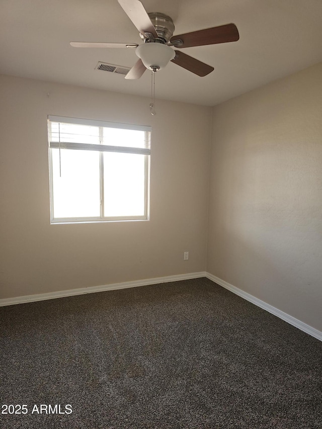 carpeted spare room featuring ceiling fan