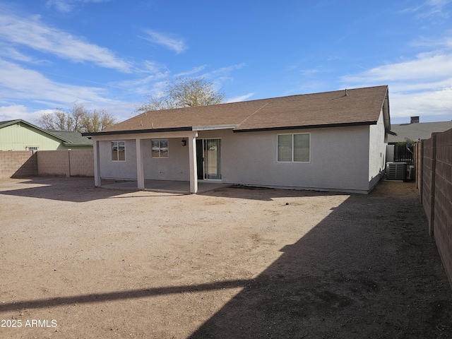 rear view of property featuring cooling unit and a patio area