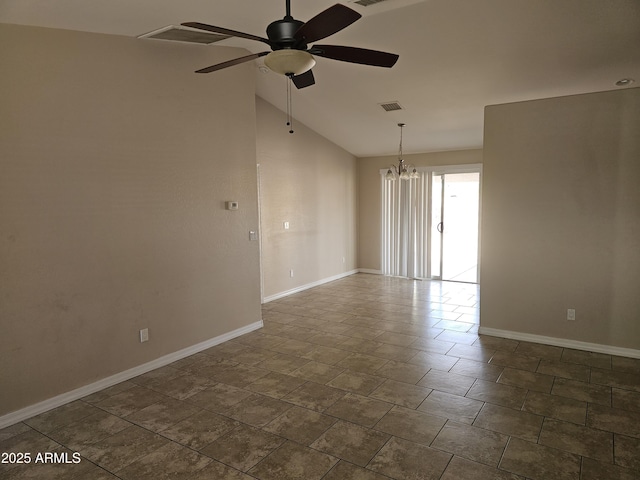 empty room featuring ceiling fan with notable chandelier and vaulted ceiling