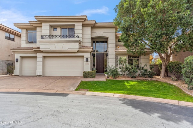 mediterranean / spanish-style house featuring an attached garage, a balcony, driveway, stucco siding, and a front lawn