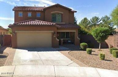 mediterranean / spanish-style home featuring a garage