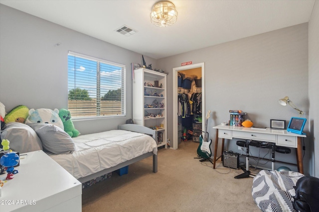 carpeted bedroom featuring a spacious closet and a closet