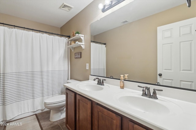 bathroom with vanity, curtained shower, toilet, and tile patterned flooring