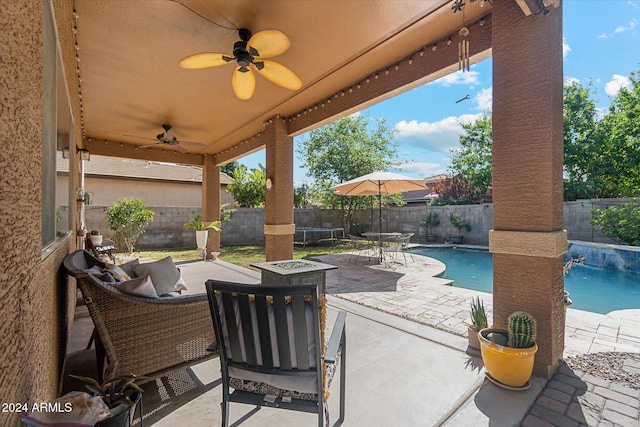 view of patio featuring a fenced in pool and ceiling fan