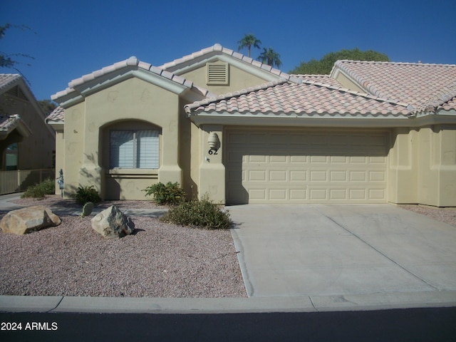 5830 E Mckellips Rd Unit 62, Mesa, AZ 85215 - view of front of home with stucco siding, a tiled roof, driveway, and a garage