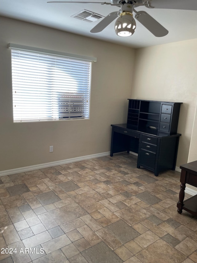 interior space with ceiling fan