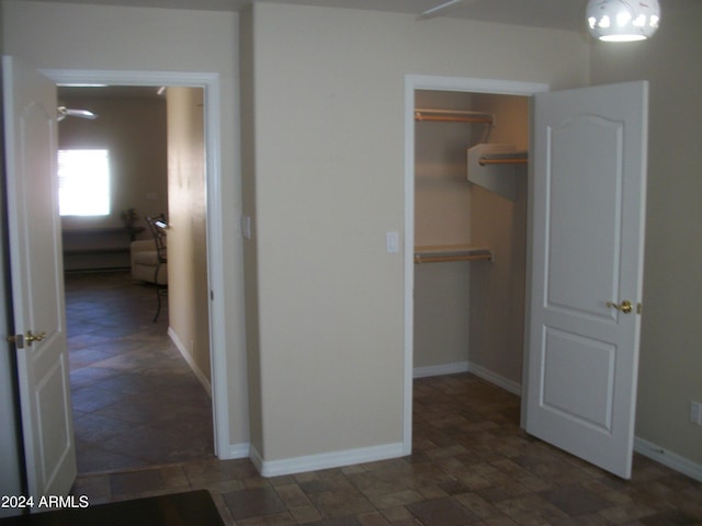 5830 E Mckellips Rd Unit 62, Mesa, AZ 85215 - interior space featuring a walk in closet, baseboards, a closet, and stone finish flooring