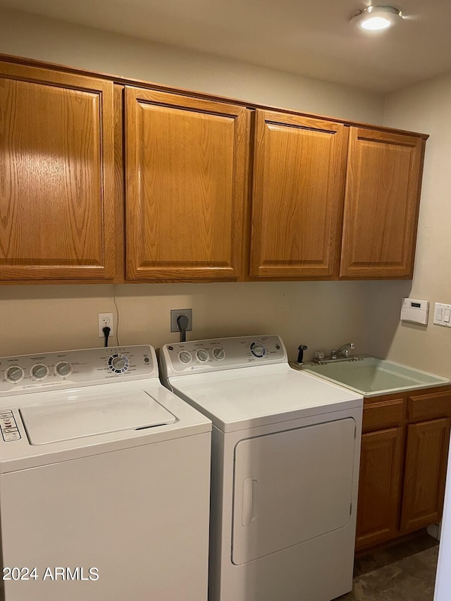 laundry area featuring cabinets, sink, and washer and dryer