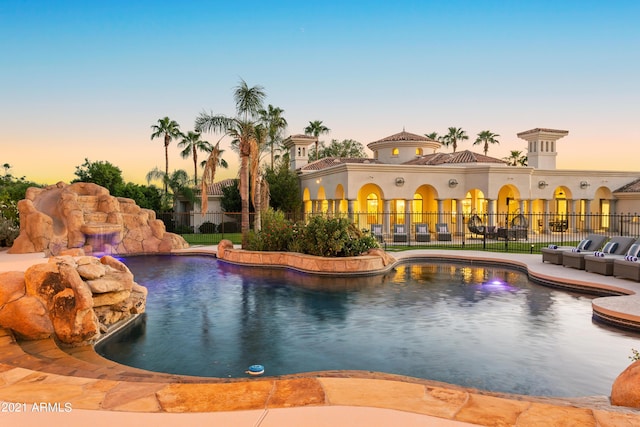 pool at dusk with pool water feature