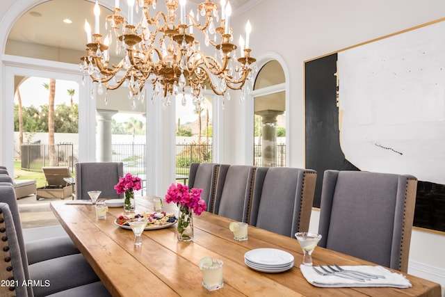 dining space with a notable chandelier and decorative columns