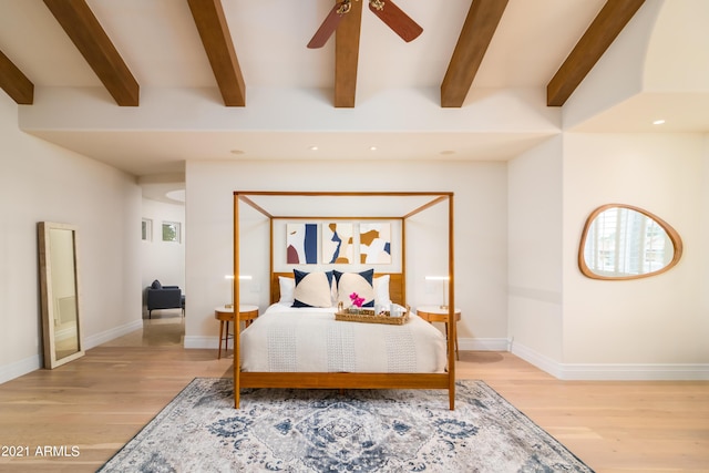 bedroom featuring beam ceiling, light hardwood / wood-style flooring, and ceiling fan