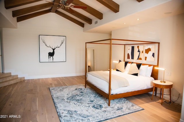 bedroom with beam ceiling, high vaulted ceiling, ceiling fan, and hardwood / wood-style flooring