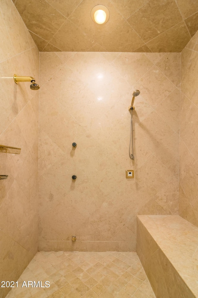 bathroom with a tile shower